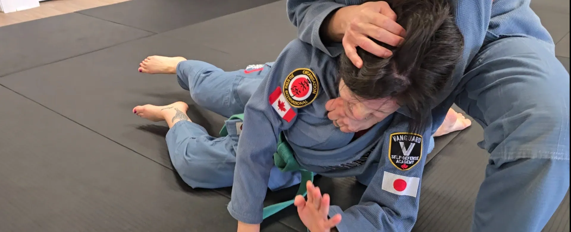 Adult students training together inside the Vanguard Self-Defense Academy dojo